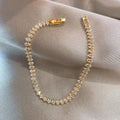 Bracelet Tennis Cristal Doré — Le bijou 5 étoiles qui transforme chaque look